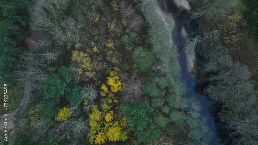 Aerial establishing view of a small dark river flowing into the Baltic sea near Liepaja (Latvia), white sand beach, overcast autumn day, wide birdseye drone shot moving forward Aerial establishing view of a small dark river flowing into the Baltic sea near Liepaja (Latvia), white sand beach, overcast autumn day, wide birdseye drone shot moving forward