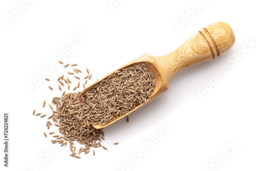 Top view of Organic Cumin Seeds (Cuminum cyminum) or jeera in a wooden scoop. Isolated on a white background.