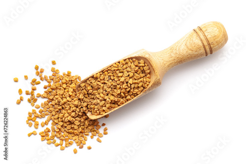 Top view of Organic Fenugreek seeds (Trigonella foenum-graecum ) in a wooden scoop. Isolated on a white background.