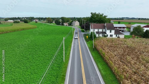 Wallpaper Mural Road through rural American countryside in autumn. Homes and farms along country road. Corn field as traffic passes. Aerial. Torontodigital.ca