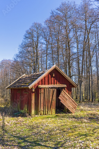 Shed with hanging doors in the countryside on a beautiful spring day