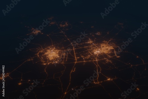 Aerial shot on Buraydah and Unaizah (Saudi Arabia) at night, view from east. Imitation of satellite view on modern city with street lights and glow effect. 3d render