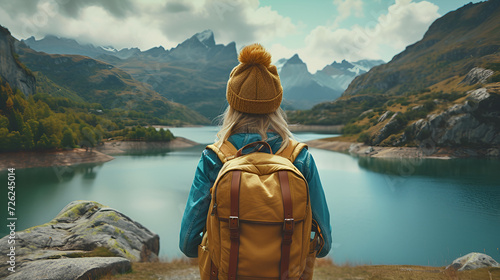 candid shot from the back of a young woman traveler in vintage style with a tourist backpack looking at the stunning view of the mountains and forest. travel and hiking concept. generative ai