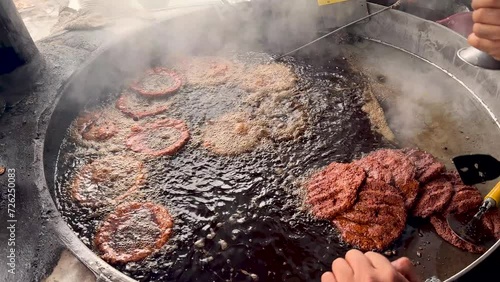 Chapli kebab is a popular street food in Pakistan. Making of chapli kabab at local food restaurant photo