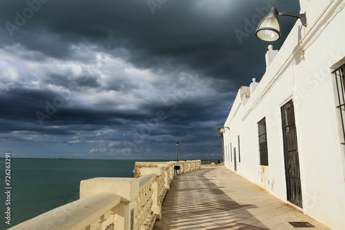Houses in the promenade of Chipiona Beach on a stormy day photo