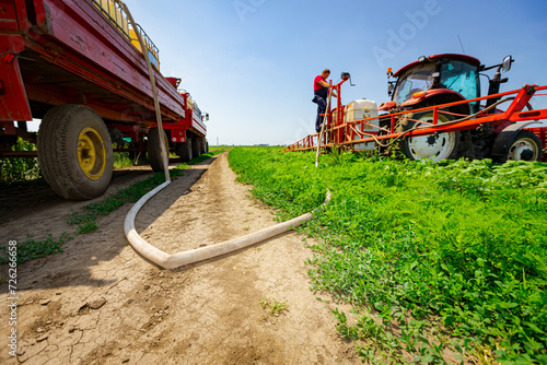 Tractor with sprayer came for reload, water, herbicide and pesticide