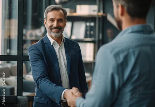 Happy businessmen shake hands after signing a cooperation agreement