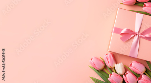 Top view of a bouquet of tulips and a gift box with a ribbon bow. Gift and pink tulips on a pastel pink background with copy space. Mother's Day and Valentine's Day concept #726274408
