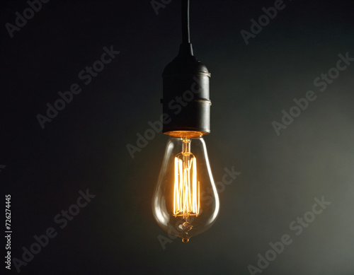 Illuminated Bulb Radiating Warm Glow in Darkness. The image captures a single glowing filament bulb against a dark backdrop, emphasizing the contrast between light and darkness. AI-Generated