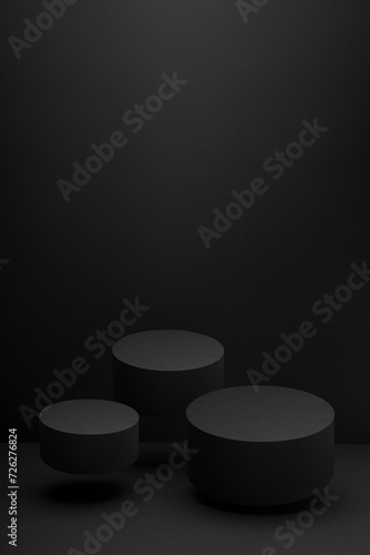 Three black round flying podiums, set, mockup on black background, shadow. Scene template for presentation cosmetic products, gifts, goods, advertising, design, display, showing in minimalist style.
