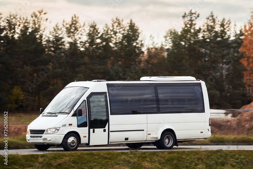 A White Motorcoach Vehicle Transports Passengers on the Road with Speed and Comfort