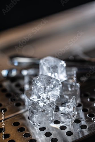Crystal clear ice cubes on the stainless steel base of the bar counter