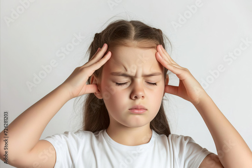Portrait of caucasian girl with closed eyes holding fingers on temples experiencing a headache on white background