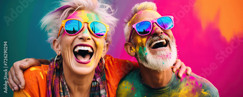 Joyful Elderly Couple Celebrating at a Colorful Holi Festival With Bright Powders