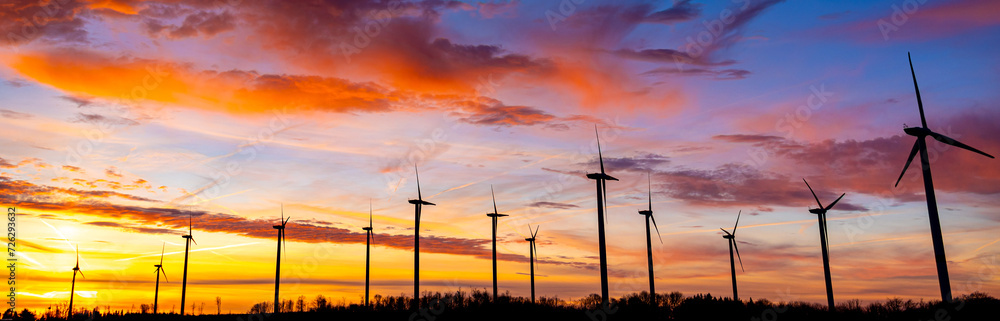 Obraz premium a modern wind park spinning in the morning light panorama