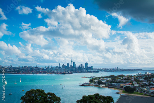 Sailing boats crossing Auckland Harbour in front of Aukland City. View from historical suburb of Devonport. North Island, New Zealand