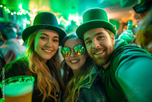 Young adults enjoy Saint Patrick Day party capturing memorable photos. Cheerful people in festive outfits take funny photos together in club