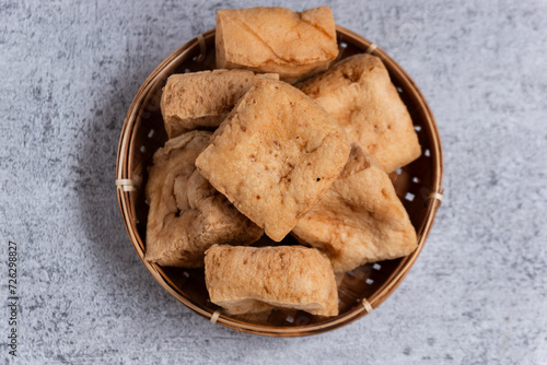 Sumedang tofu is typical tofu of the Sumedang area, also known as PONG tofu, with a textured gray background photo