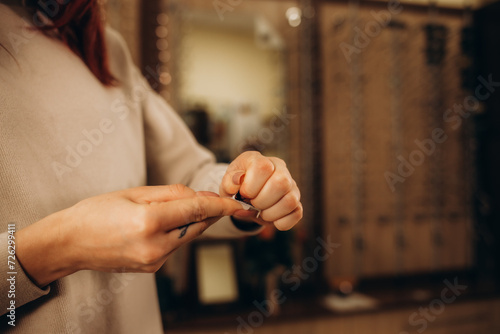 Woman opening a case containing a contact lens. Vision Correction and Health Care. Contact Lenses. photo