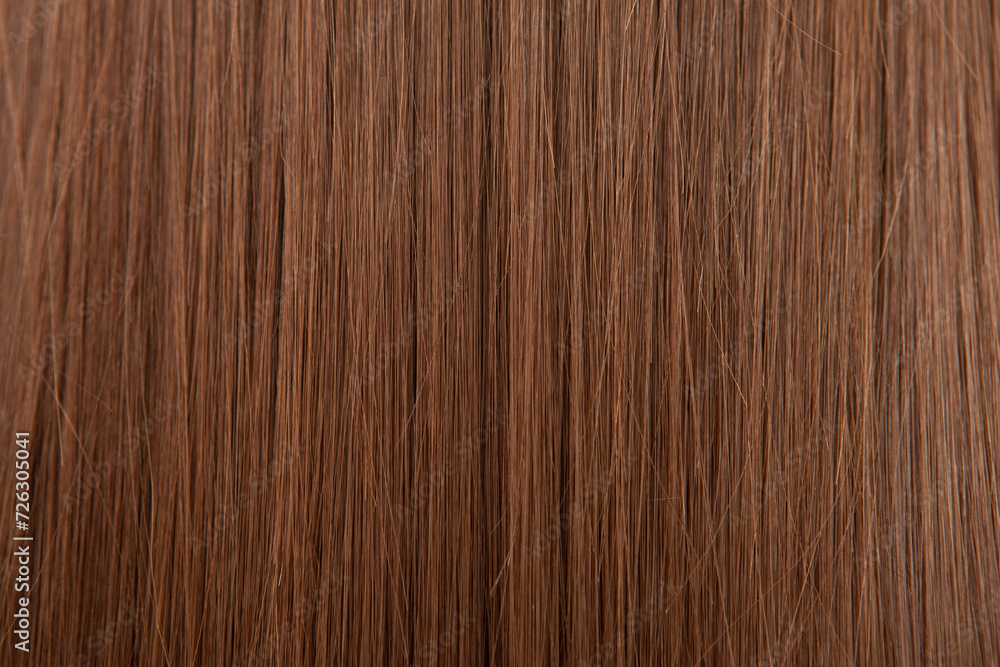 Naklejka premium Close up of brown hair as background. Texture of natural hair..