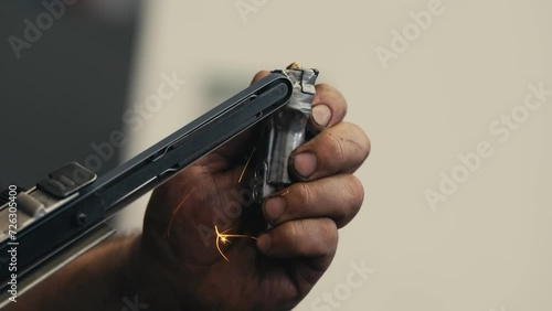 man sharpens a metalworking drill bit