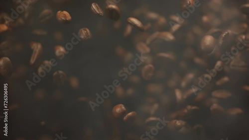 Super slow motion shot of falling roasted coffee beans with smoke in macro. Roasting flying coffee. Whole coffee explosion close up video photo