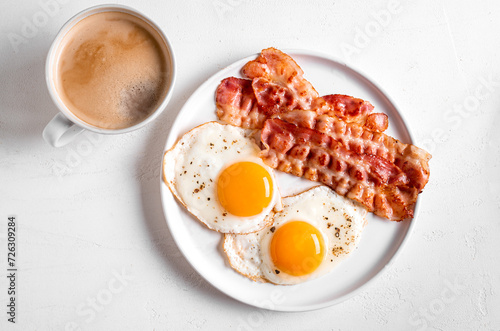 Breakfast with fried eggs, bacon and coffee