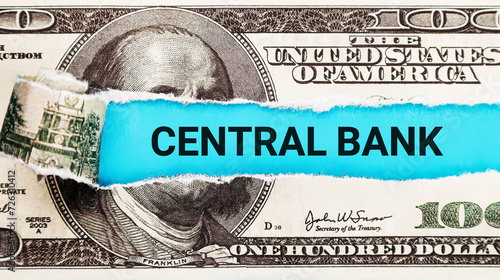 Central Bank. The word Central Bank in the background of the US dollar. Monetary Policy, Currency Issuance, and Economic Stability Concept photo