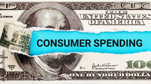 Consumer Spending. The word Consumer Spending in the background of the US dollar. Consumerism, Retail, and Economic Consumption Concept.