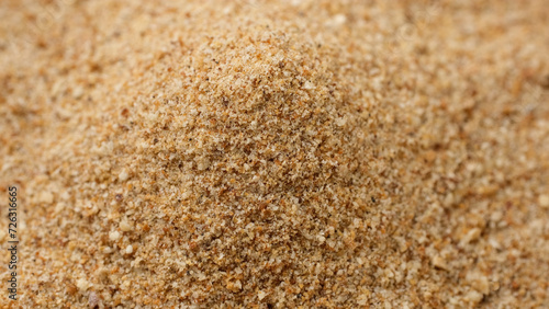 Sprinkle breadcrumbs on heap, close up