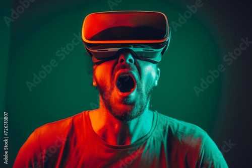 Shocked man in VR headset on green background. Virtual reality, augmented reality concept. VR / AR metaverse simulation. Futuristic technology and future gaming © dreamdes