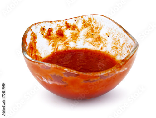 Tomato sauce . Glass cup with remaining ketchup