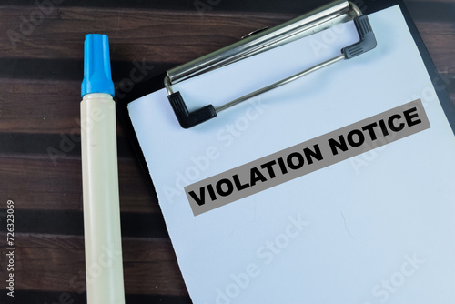 Concept of Violation Notice write on paperwork isolated on wooden background. photo