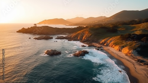 Aerial beautiful shot of a seashore with hills on the background at sunset © Tahir