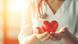 Doctor holding red heart symbol of life