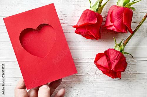 red roses and heart shaped greeting card