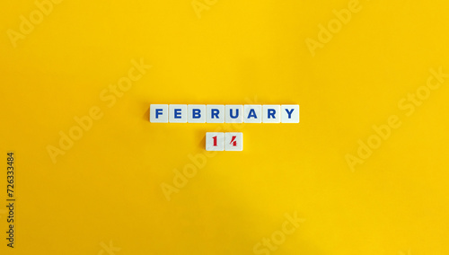 February 14. Block Letter Tiles on Yellow Background. Minimal Aesthetics.