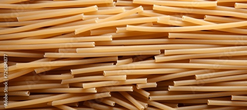 Close up top view of traditional italian pennettine pasta as abstract background