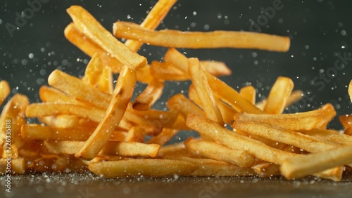 Flying French Fries Falling on Table. Fast Food Concept with Flying Food.