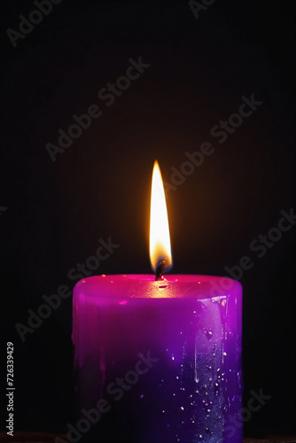  Purple candle burning with streaks of paraffin on dark background