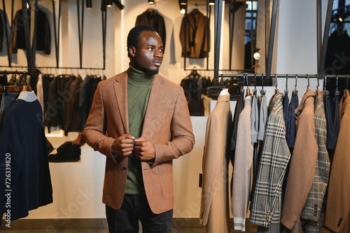 African businessman in elegant classic suit in a premium men's clothing store photo
