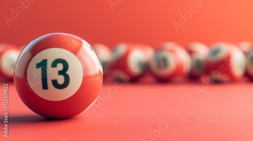 Close up of red lottery balls on pastel background with focus on lucky number 13 photo