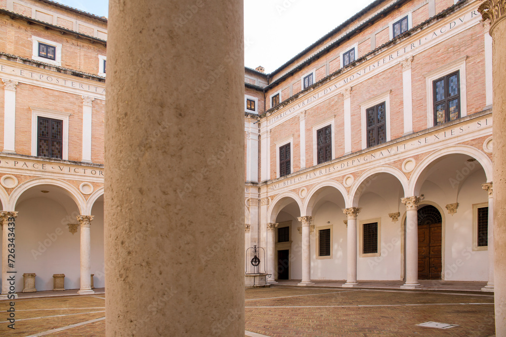 Internal courtyard of the ducal palace of Urbino, in the Marche region, Italy. The square is empty and there is no one in this ancient building, legacy of the Italian Renaissance.