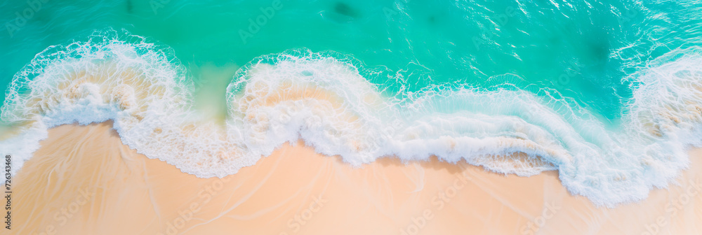 Aerial view of beach waves on a tropical sandy shore. Concept of summer holiday and exotic travel.	
