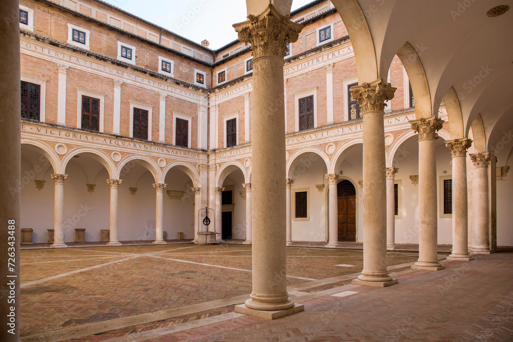Internal courtyard of the ducal palace of Urbino, in the Marche region, Italy. The square is empty and there is no one in this ancient building, legacy of the Italian Renaissance.