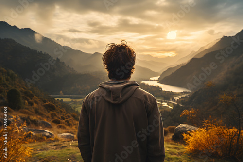 Man taking a look at the mountain top views after hiking. Concept: travel, healthy life, nature, adventure. © Natalia