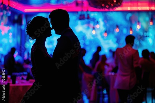 Silhouettes of a dancing wedding couple in a restaurant