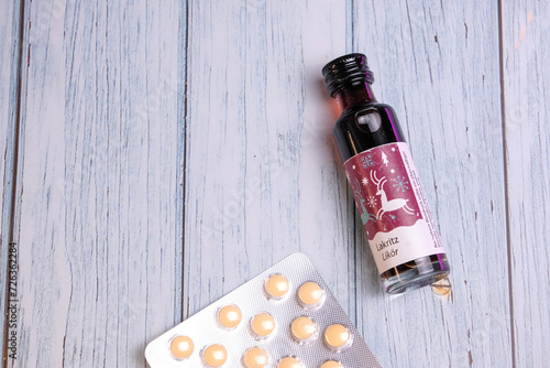 Tiny bottle of lakritz licorice liqueur with pregnancy pills on the back