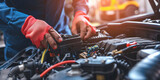 Mechanic Connecting Jumper Cables on Car Battery in Auto Repair Workshop