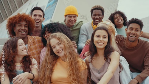 Multiethnic group of teenagers hanging out in the city center. Concepts about campus university students, friendship, and generation z photo
